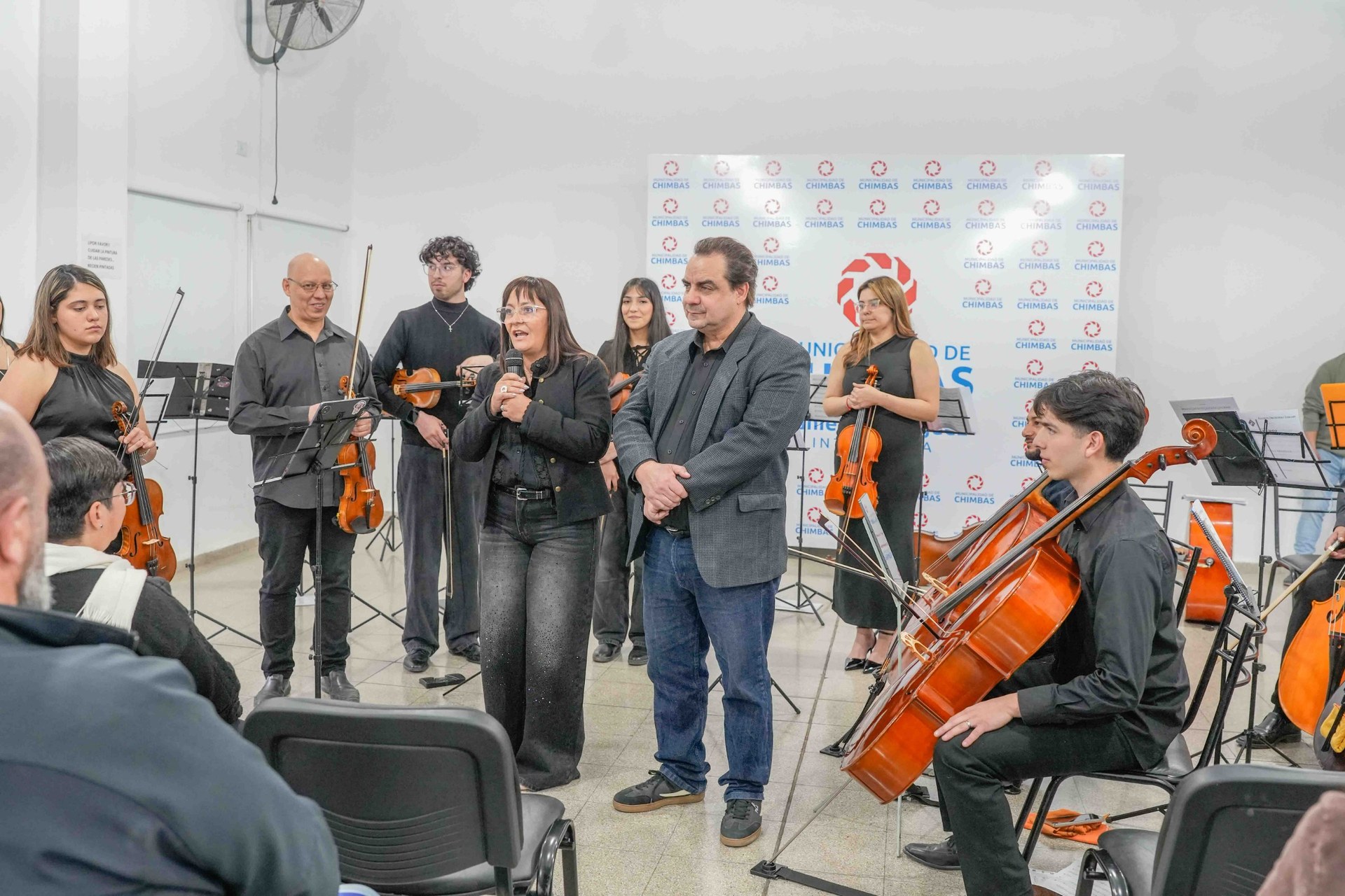 Autoridades y músicos comparten un momento durante el concierto.